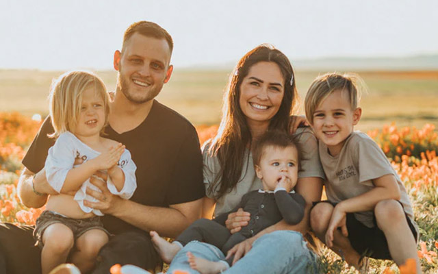 Family sitting in field